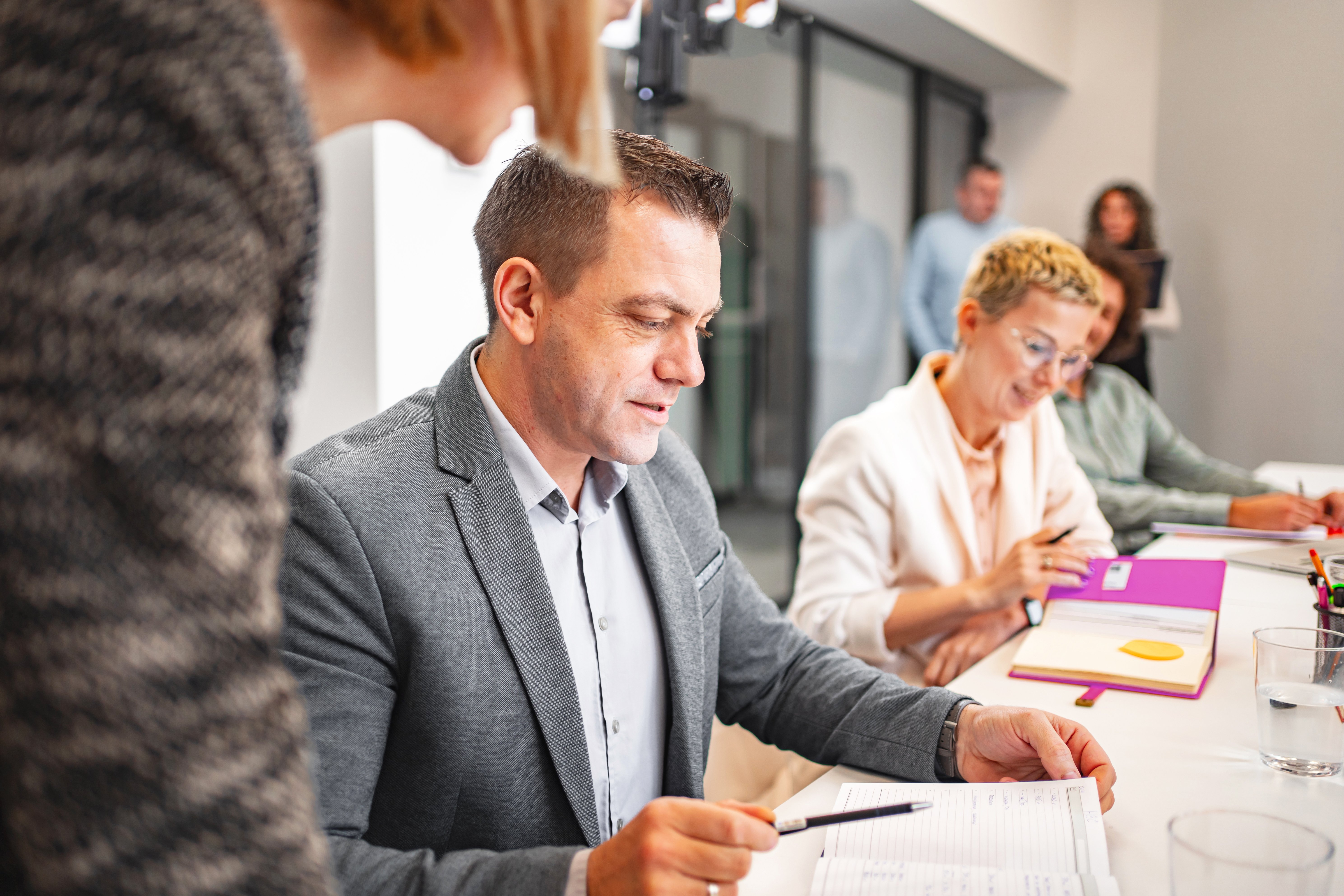 GettyImages-1884220155-Man_and_People_Conference_Room-RET (1)